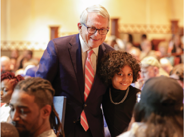 governor dewine posing with young blakc student